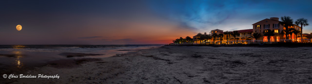 On St. Simons Island, Georgia, the sun falls behind the King and Prince Beach & Golf Resort as a full moon rise reflects across the ocean.